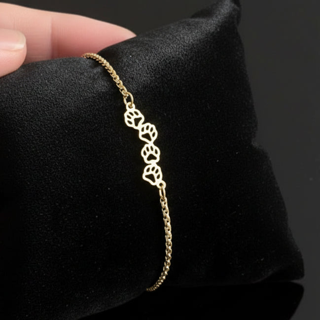 4 paw prints on a gold adjustable bracelet