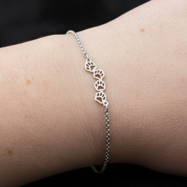 cute paw prints bracelet, silver coloured. adjustable